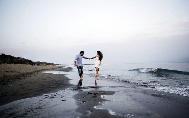 A couple walking along a beach