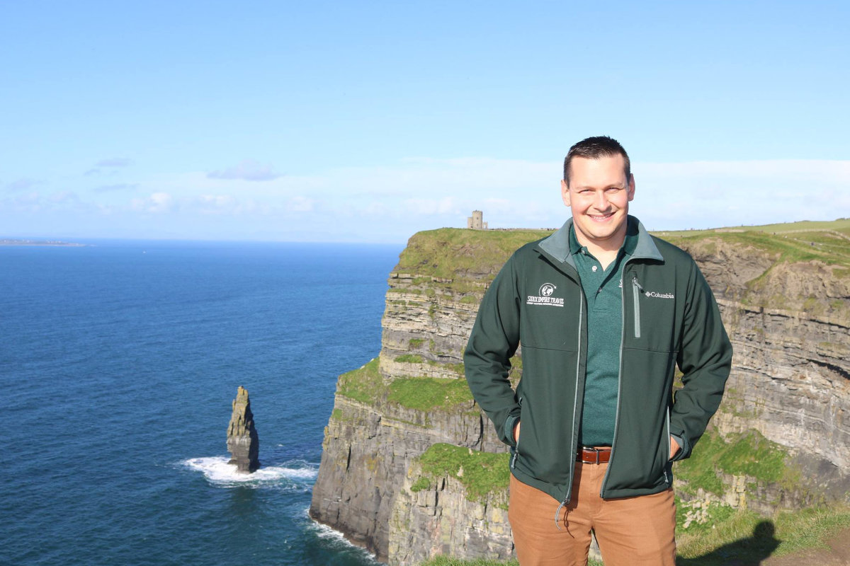 Picture of Tyson standing above the ocean cliffs in Ireland